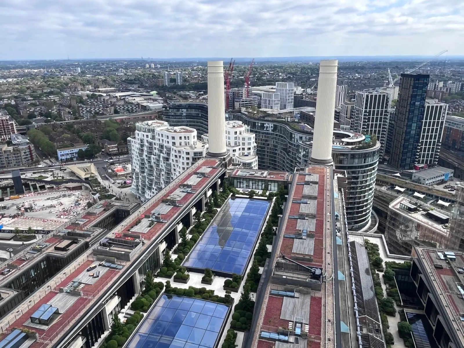 Aerial view of Battersea Power Station estate showing the iconic chimneys and surrounding development