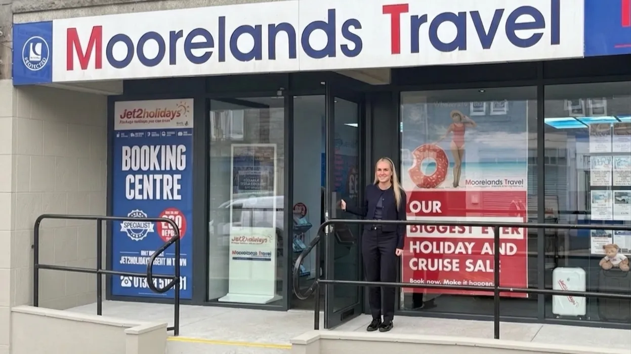 Moorelands Travel front door with smiling team member welcoming you in