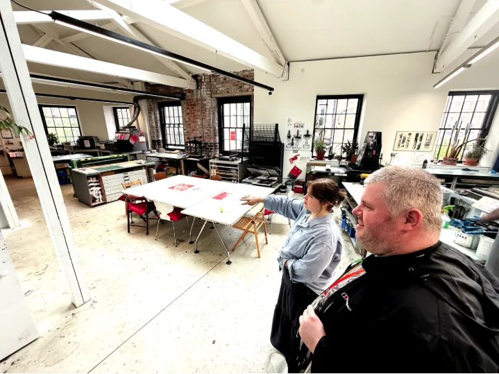 It's hard not to be inspired when the artists themselves give you a tour of their remarkable venue — Eilidh shows David around one of the printmaking studios, pointing across a wide room full of tables and printmaking machinery