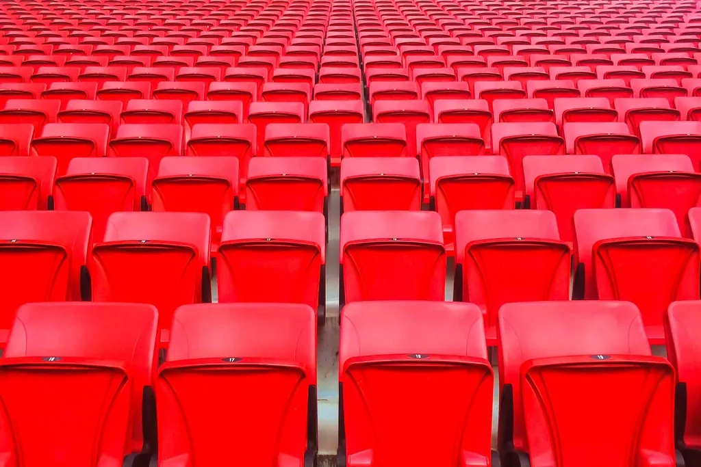 Rows of red plastic stadium seats